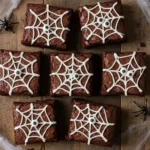 Spiderweb brownies with white icing and candy eyes on a Halloween table.